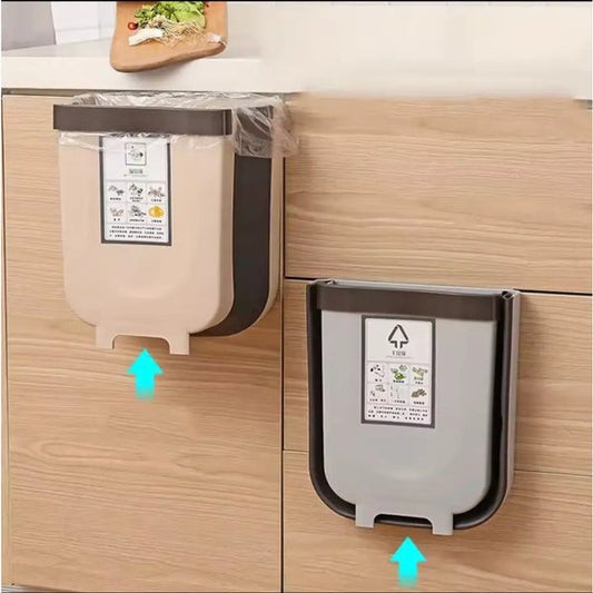 Wall mounted kitchen trash bin in beige and gray attached to wooden cabinet doors for space-saving waste disposal