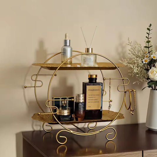 Clarify.pk 2 tier bathroom organizer in gold metal with shelves holding skincare and fragrance bottles