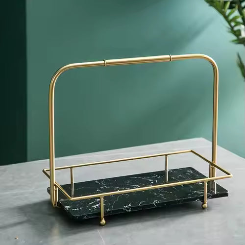 Clarify.pk iron display stand for snacks with gold frame and black marble base on gray surface