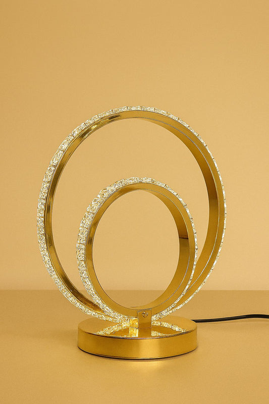 Modern gold LED bedside lamp with circular rings and crystal detailing by Clarify.pk