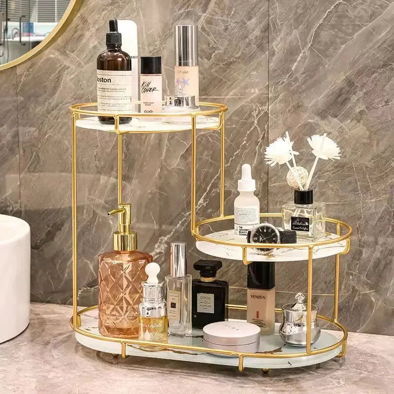 Clarify.pk cosmetics organizer with gold frame and marble shelves holding skincare and beauty products