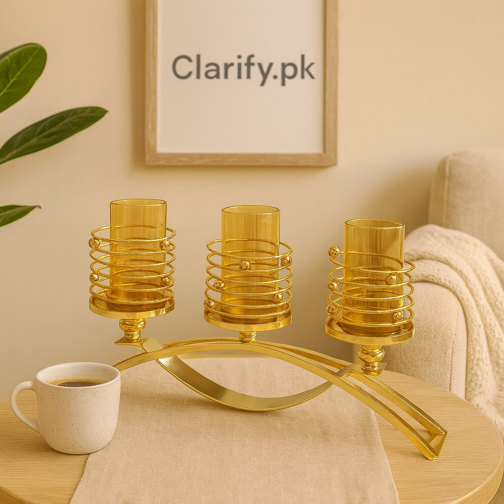 Elegant golden triple candle holder with spiral design and three glass cups on wooden table