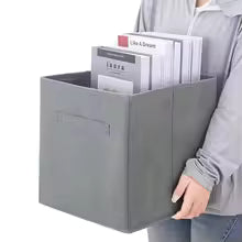 Gray non-woven storage basket with handle holding books and documents for easy carrying