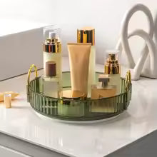 Clarify.pk 360 rotating makeup organizer in green with multiple compartments holding makeup bottles and tubes