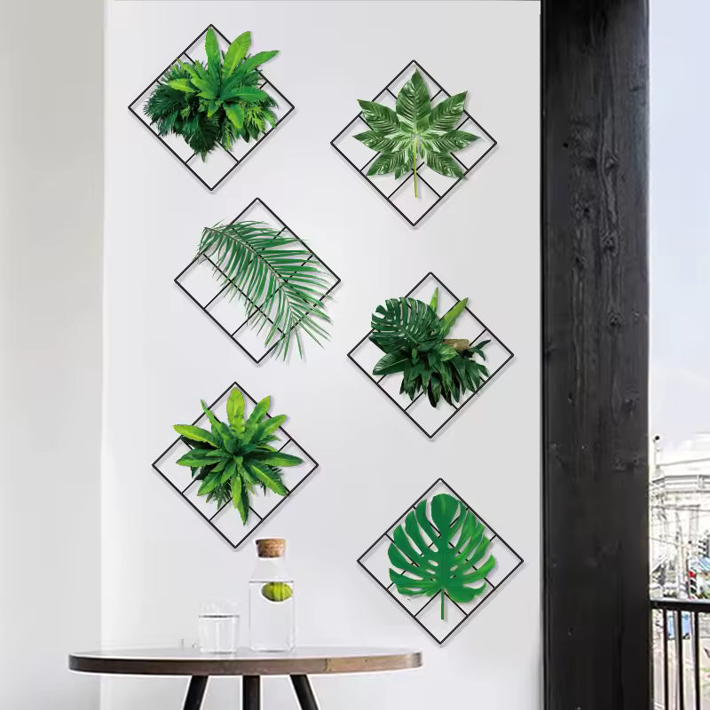 Green plant wall stickers arranged in black diamond frames on a white living room wall