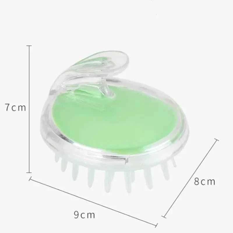 Clear and green silicone scalp massage brush with soft bristles and ergonomic handle by Clarify.pk