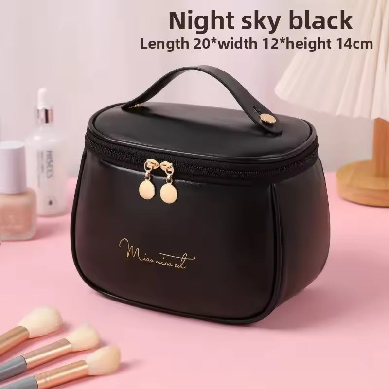 Night sky black PU leather handheld makeup wash bag with gold zipper and handle by Clarify.pk