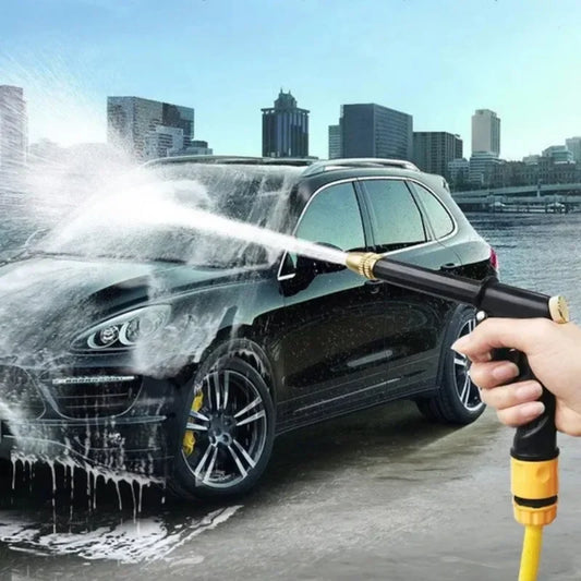 High pressure water gun spraying water to wash black SUV in city outdoor setting