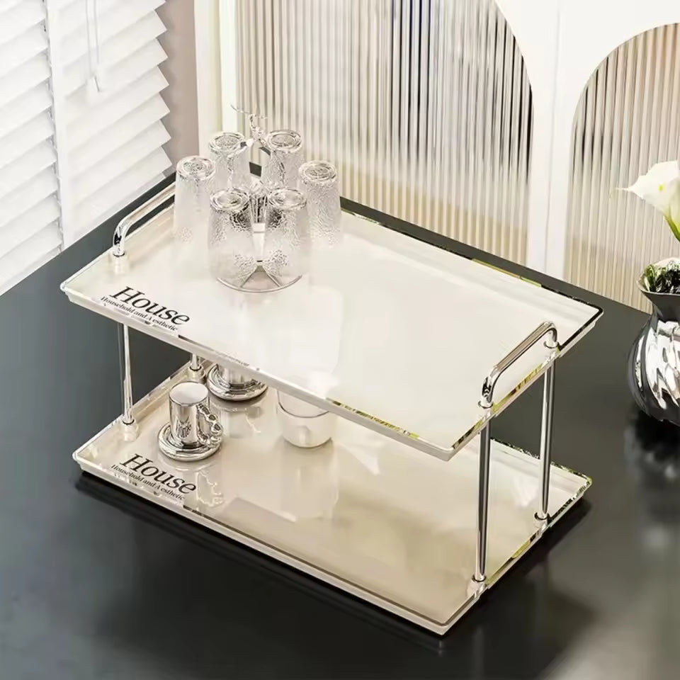 Clarify.pk 2 tier desktop cup rack organizer with metal frame and white trays holding glass cups and tea set