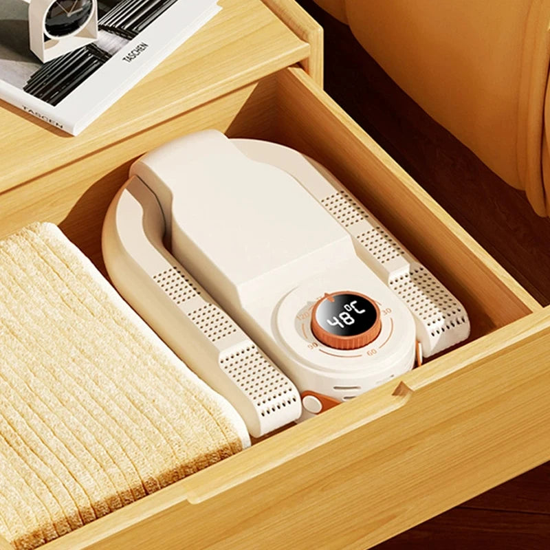 Clarify.pk Intelligent Timer Shoe Dryer neatly placed in wooden drawer next to towel for efficient shoe drying