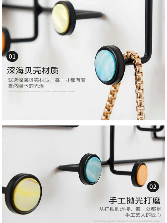 Close-up of colorful round hooks on black metal frame iron art key holder for home hanging chains