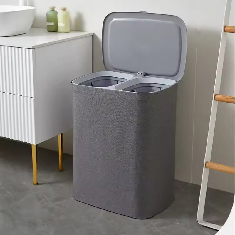 Japanese style clothes hamper in gray with dual compartments and hinged lid for laundry organization