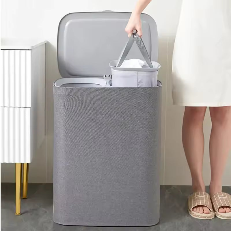 Gray Japanese style clothes hamper with removable inner basket held by person in white dress