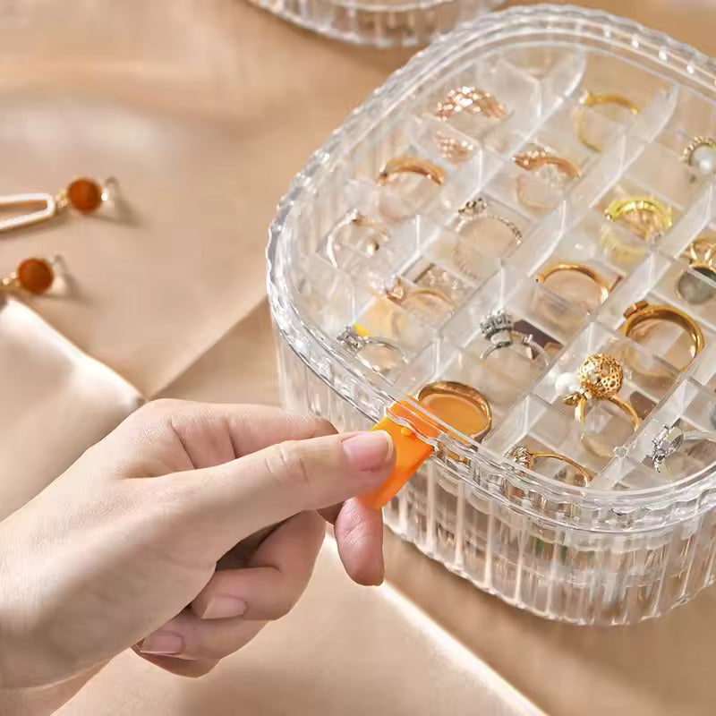 Clear 3 layer jewelry storage case by Clarify.pk with multiple compartments holding rings and accessories