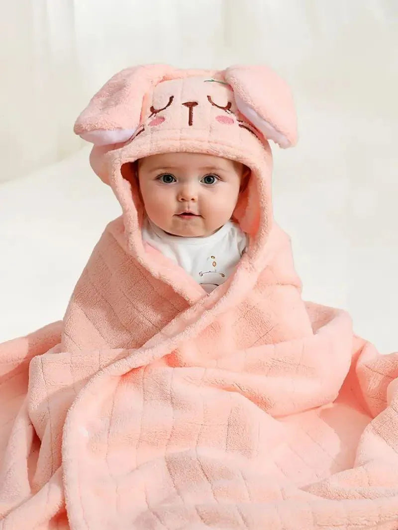 Baby wrapped in a soft pink kids hooded bathrobe animal design with cute ears and face on the hood