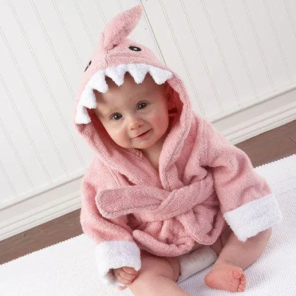 Baby wearing pink kids hooded bathrobe animal design with white teeth and ears sitting on white rug