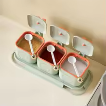 3 piece spice container set for kitchen with clear lids and white measuring spoons on a tray