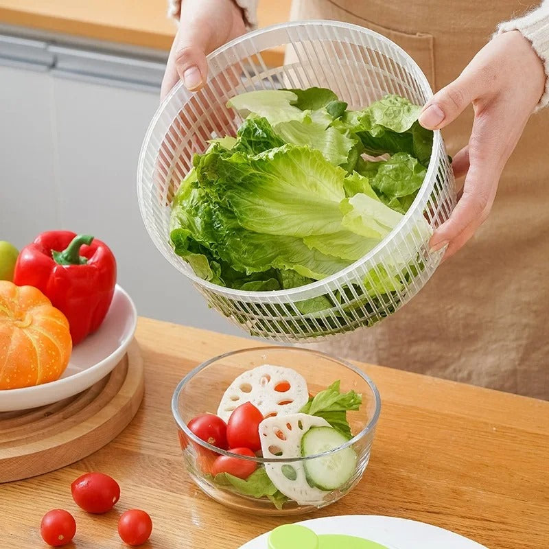 Hands holding clear plastic basket draining lettuce into bowl with tomatoes cucumber greens multifunctional lettuce drain basket
