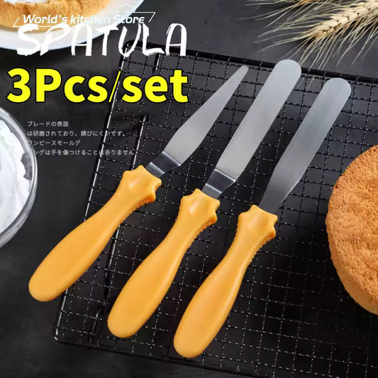 Clarify.pk cake spatula 3 piece set with yellow handles and stainless steel blades on cooling rack