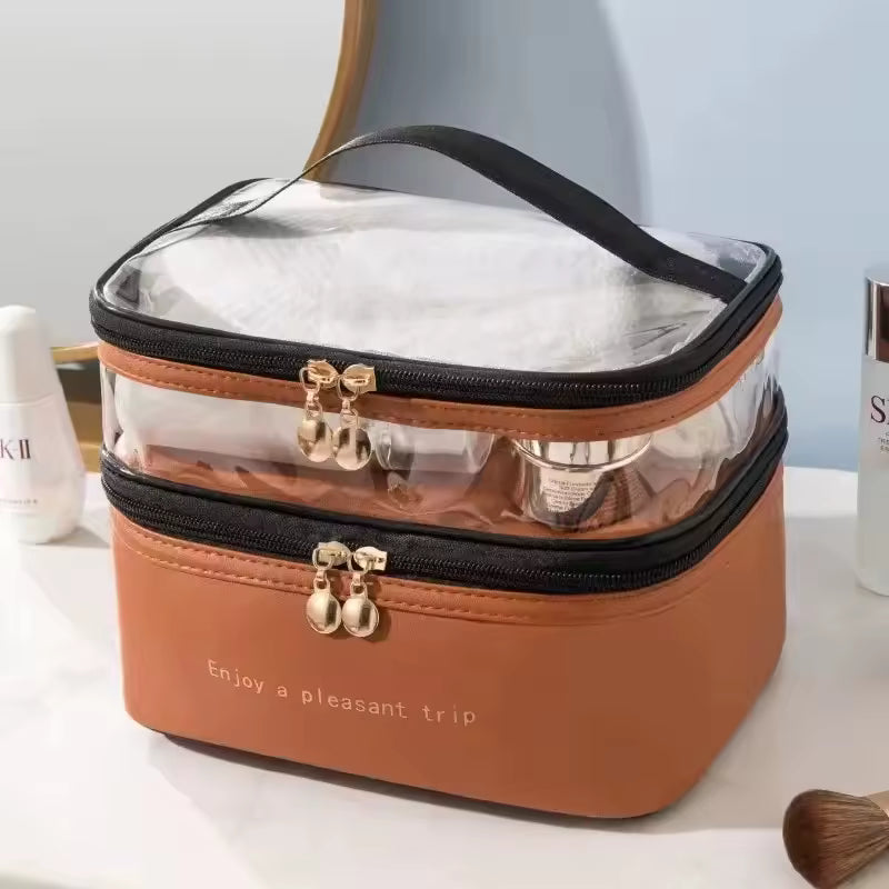 Large capacity makeup organizer with clear top compartment and brown base for travel and storage