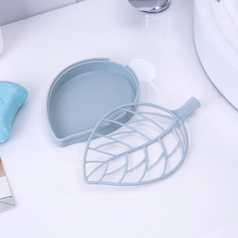 Clarify.pk leaf shape soap dish in light blue with a slotted top for drainage on a white bathroom sink