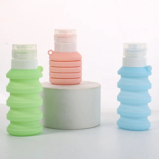 Colorful leakproof refillable shampoo bottles in green, pink, and blue with collapsible design