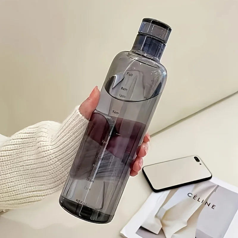Clarify.pk leakproof sport water bottle in smoky gray held by hand with measurement markings