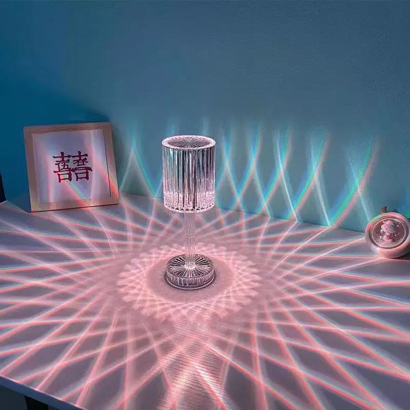 Clarify.pk led crystal projection lamp creating colorful geometric light patterns on a white table and wall