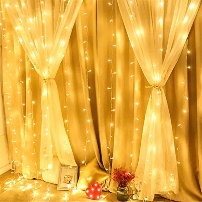 Warm white LED curtain lights for home decor hanging over beige curtains with decorative heart and flowers