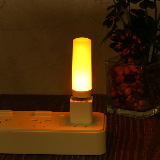 Clarify.pk LED flame effect night light plugged into white power strip glowing warm yellow