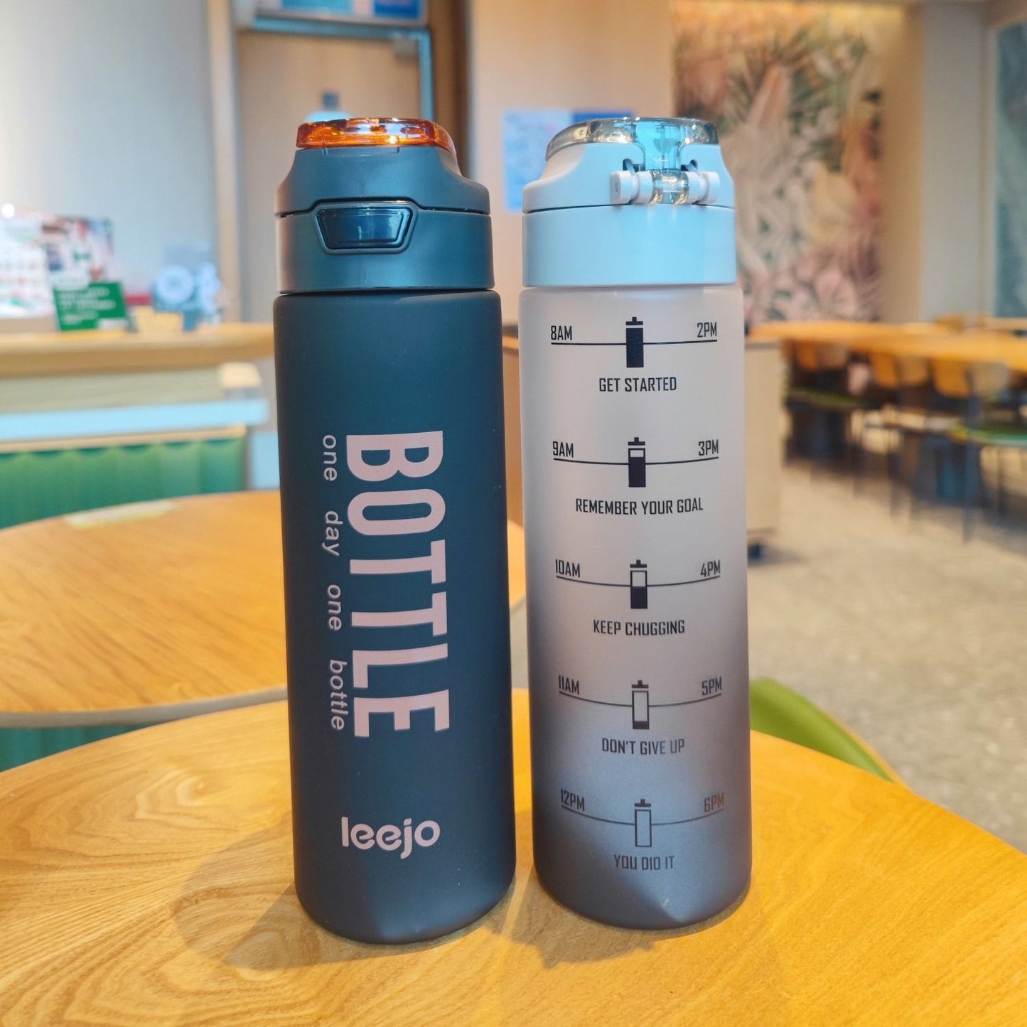 1000ml sports water bottle in black and gray with motivational time markers for hydration tracking