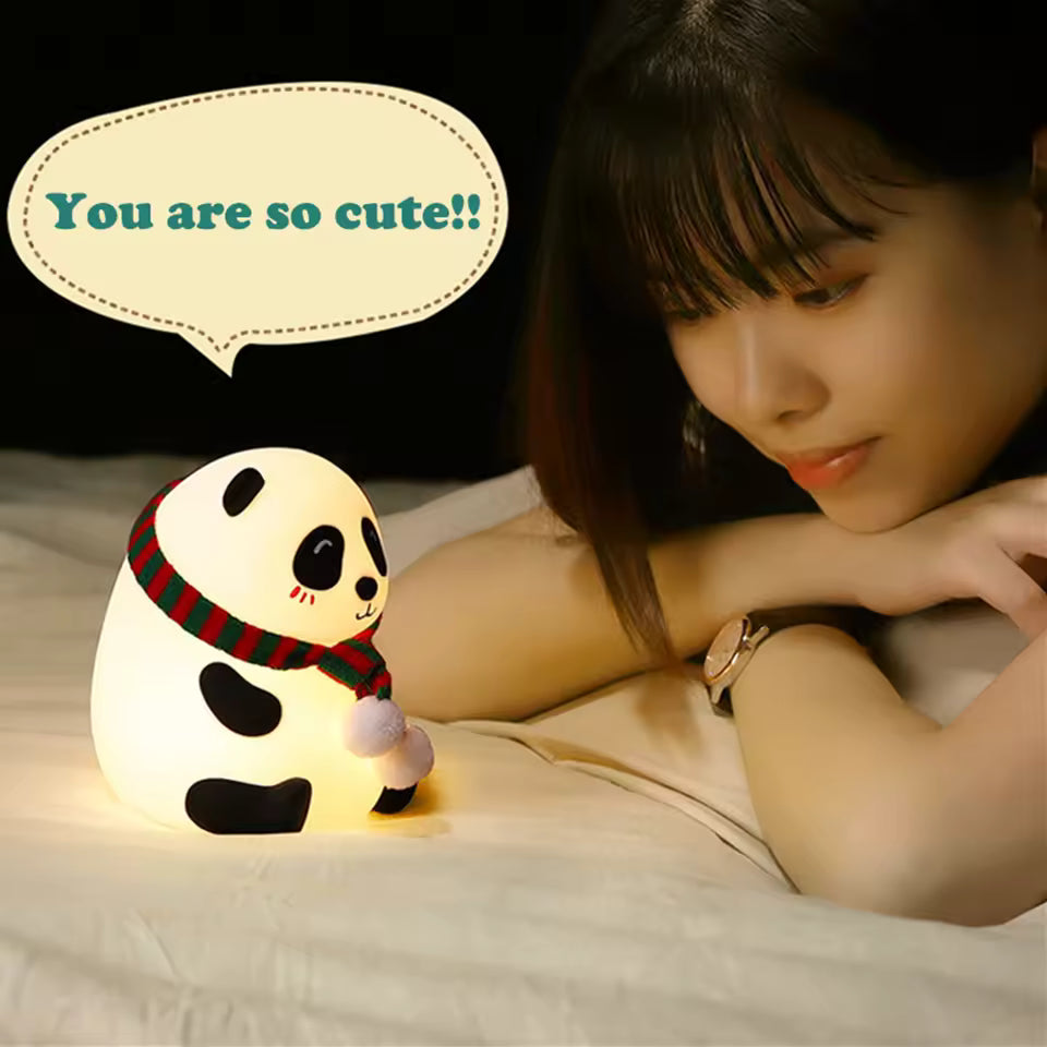 Cute silicone panda lamp night light on bed glowing with woman smiling nearby