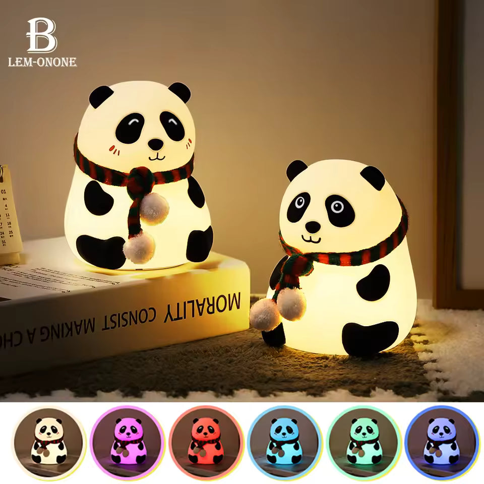 Cute silicone panda lamp night light with scarf glowing softly on a table at night