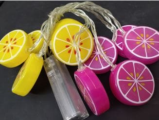 Clarify.pk lemon slice string lights featuring yellow and pink citrus designs on a clear wire