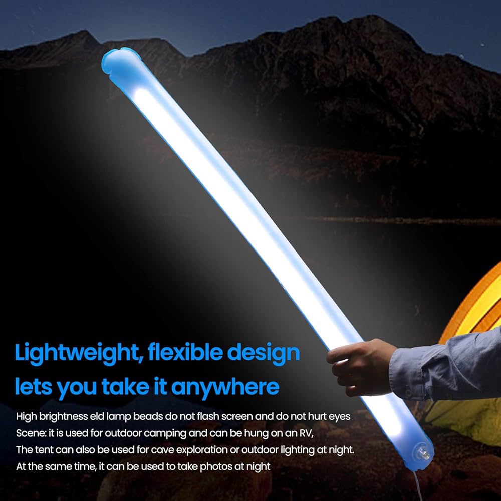 Hand holding a glowing camping inflatable light outdoors at night near a tent and mountains