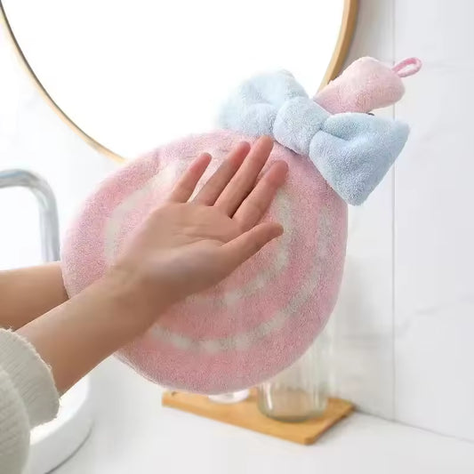 Clarify.pk lollipop design bathroom towel in pink and white with blue bow held near sink