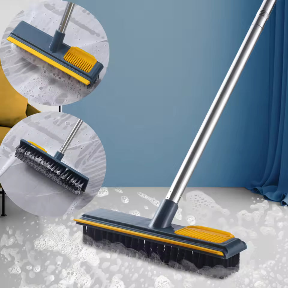 Clarify.pk long handle floor cleaning brush with black bristles and yellow scrubbing pad on soapy floor