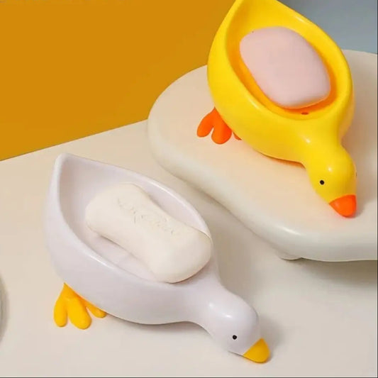 Cartoon duck soap dish in yellow and white holding soap bars, playful bathroom accessory