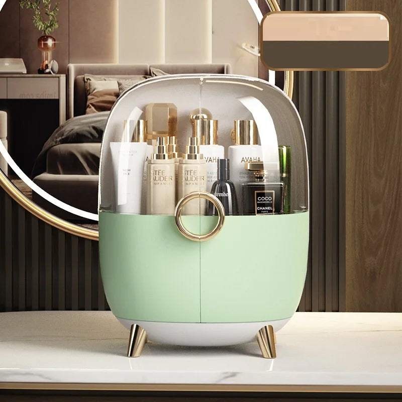 Luxury cosmetics storage box in pastel green with transparent cover and gold accents on vanity table