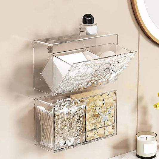 Clear wall-mounted cotton pad storage container holding cotton pads and cotton swabs for organized bathroom storage
