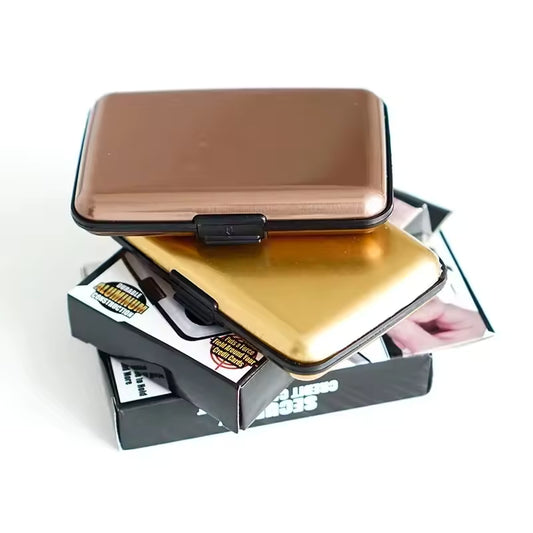 Clarify.pk aluminium wallet for cards in bronze and gold colors stacked on packaging boxes