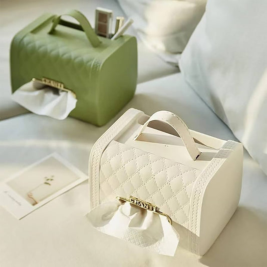 White and green handbag tissue box holder with quilted design and top handle on sofa