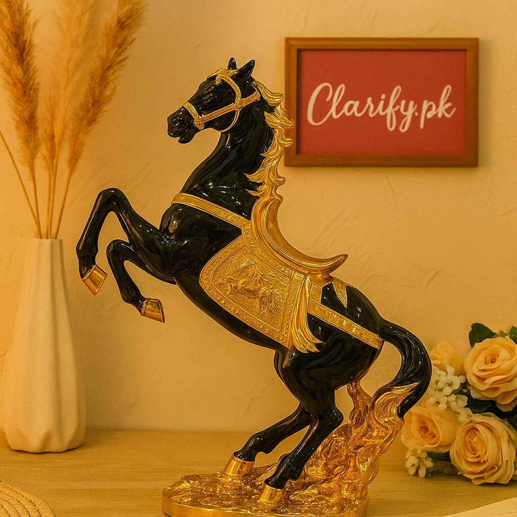 Black and gold luxury horse statue decor with detailed saddle and mane on wooden surface