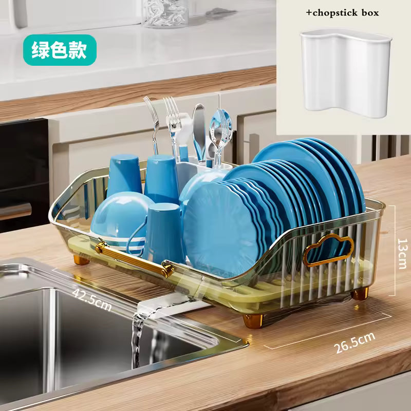 Luxury kitchen dish drainer in gold with multiple compartments holding blue plates, cups, and utensils