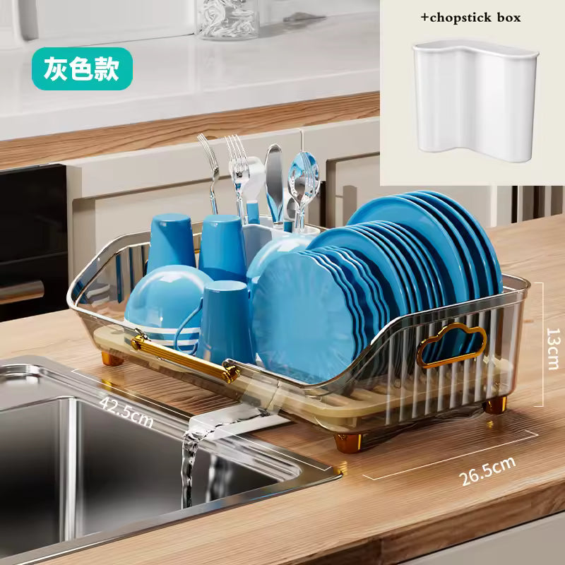Luxury kitchen dish drainer with gold accents holding blue plates cups and cutlery near kitchen sink