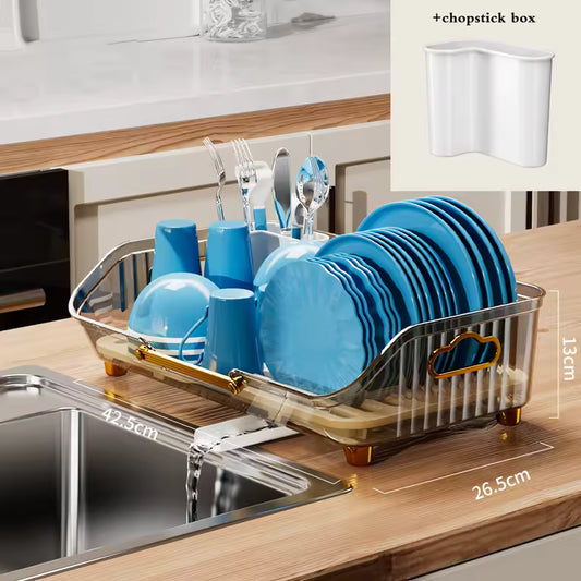 Luxury kitchen dish drainer with gold accents holding blue dishes and utensils next to a kitchen sink
