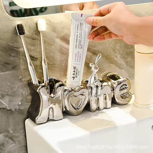 Luxury toothbrush holder for bathroom shaped like the word home with toothbrushes and toothpaste