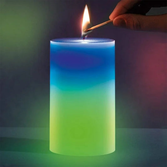 Colorful lit magic wax mood candle being ignited with a matchstick creating a calming ambiance