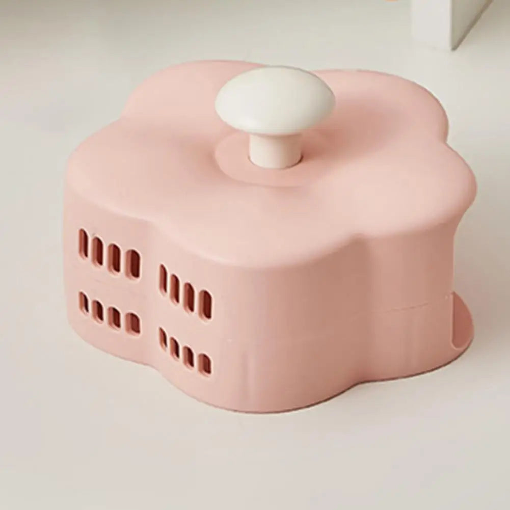 Pink flower-shaped makeup brush organizer box with white knob for easy access
