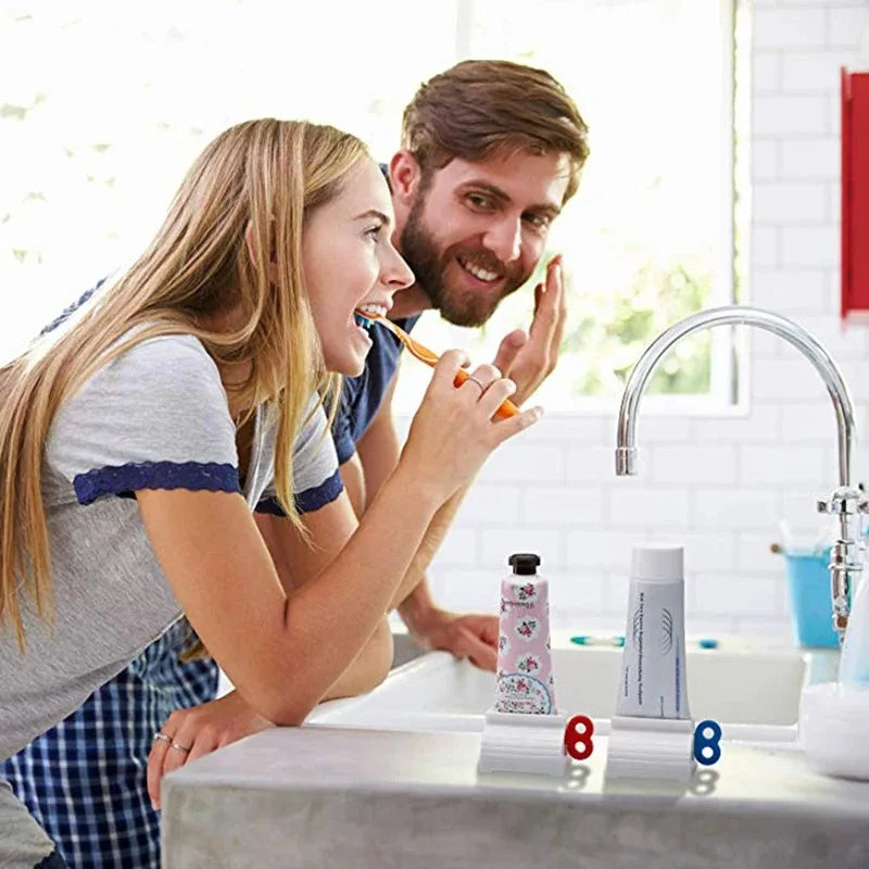 Couple brushing teeth using manual toothpaste squeezer in modern bathroom sink